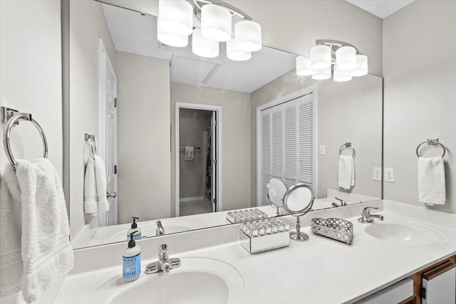 full bath with double vanity, a closet, and a sink