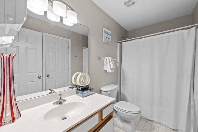 full bathroom with visible vents, toilet, tile patterned floors, a textured ceiling, and vanity