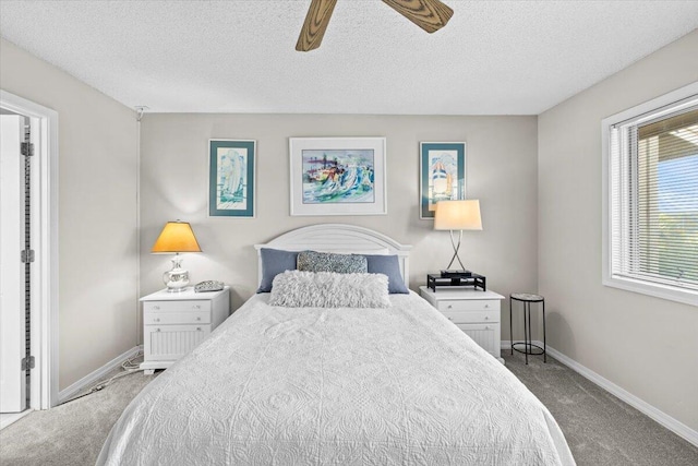 carpeted bedroom with a textured ceiling, ceiling fan, and baseboards