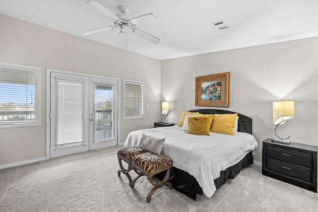 bedroom featuring light carpet, multiple windows, visible vents, and access to exterior