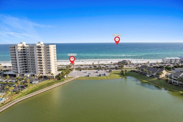 drone / aerial view featuring a water view and a beach view