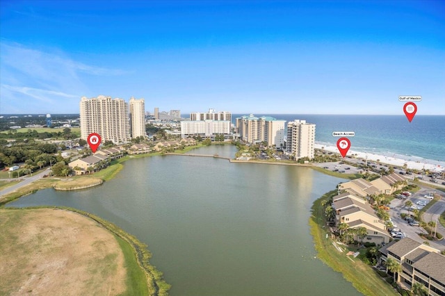 birds eye view of property featuring a water view, a view of the beach, and a city view