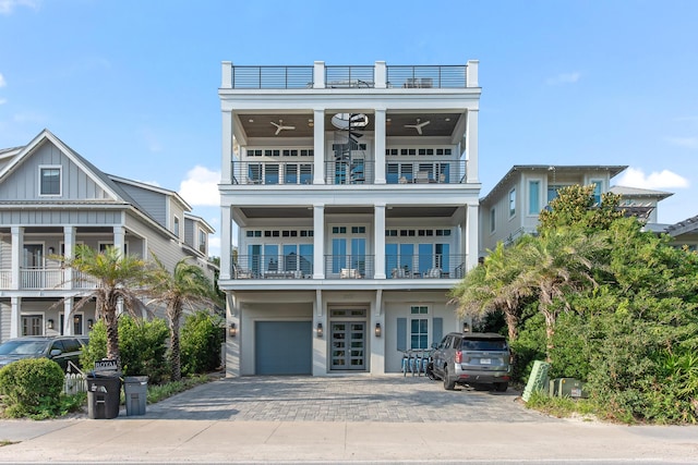 raised beach house featuring ceiling fan, french doors, and a balcony