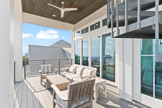 wooden terrace with ceiling fan and an outdoor living space