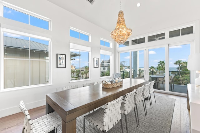 dining room featuring light hardwood / wood-style flooring and a notable chandelier