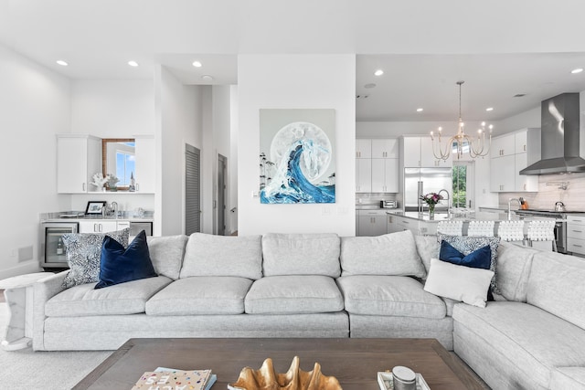 living room with an inviting chandelier, wine cooler, and sink