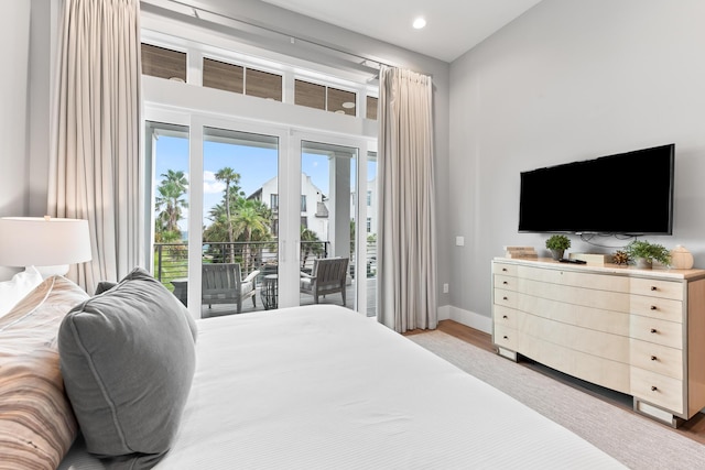 bedroom with light wood-type flooring and access to exterior