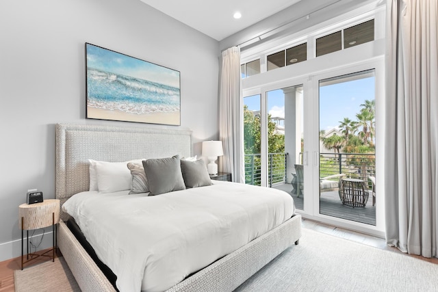 bedroom featuring access to exterior and hardwood / wood-style floors