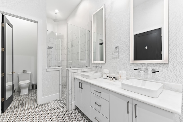 bathroom with toilet, an enclosed shower, and vanity