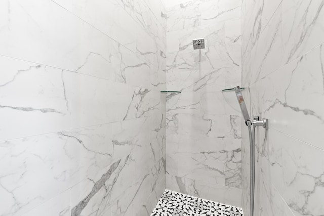 bathroom with a tile shower