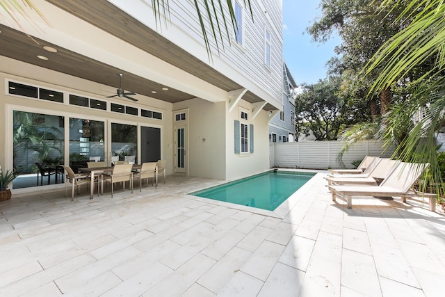 view of swimming pool featuring ceiling fan and a patio area