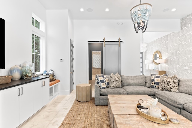 living room featuring a barn door and an inviting chandelier