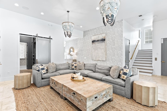 living room featuring a barn door and a chandelier