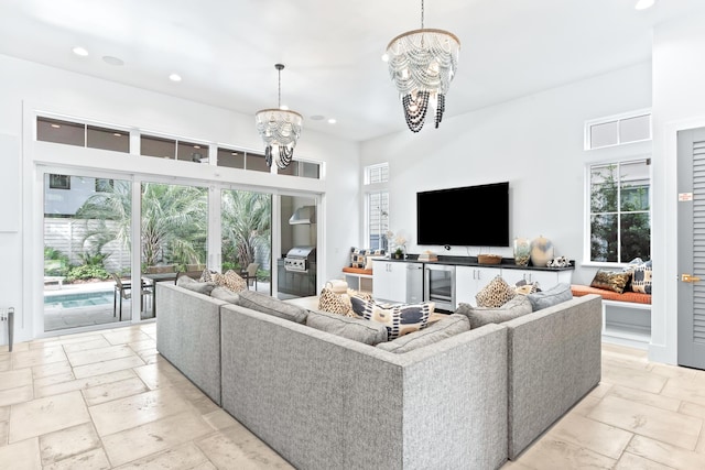 living room with wine cooler and an inviting chandelier