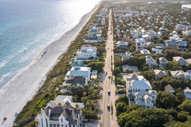 aerial view with a water view and a beach view