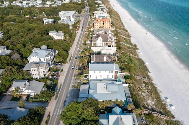 birds eye view of property featuring a beach view and a water view