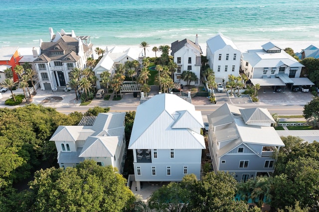 birds eye view of property featuring a water view and a beach view