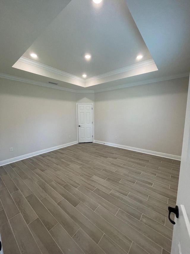 846 Coastal Breeze Dr, Freeport, FL 32439 - spare room with a tray ceiling, ornamental molding, dark wood finished floors, recessed lighting, and baseboards