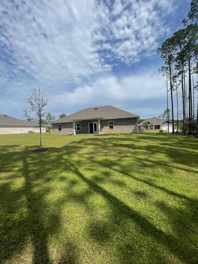 846 Coastal Breeze Dr, Freeport, FL 32439 - rear view of property with a lawn