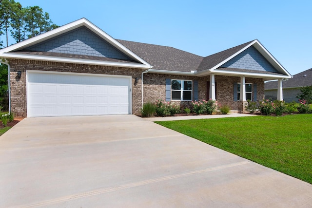 846 Coastal Breeze Dr, Freeport, FL 32439 - craftsman house featuring concrete driveway, brick siding, a front yard, a garage, and a shingled roof