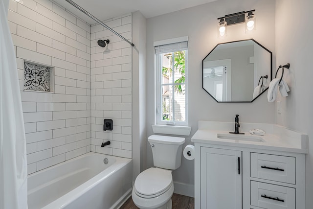 full bathroom featuring hardwood / wood-style floors, toilet, vanity, and shower / tub combo with curtain