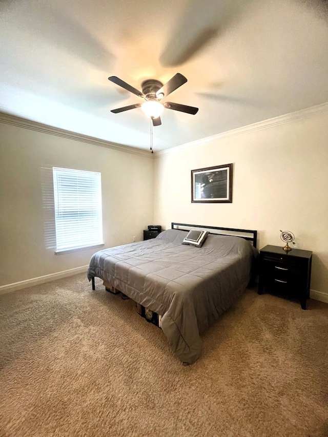 carpeted bedroom featuring crown molding and ceiling fan