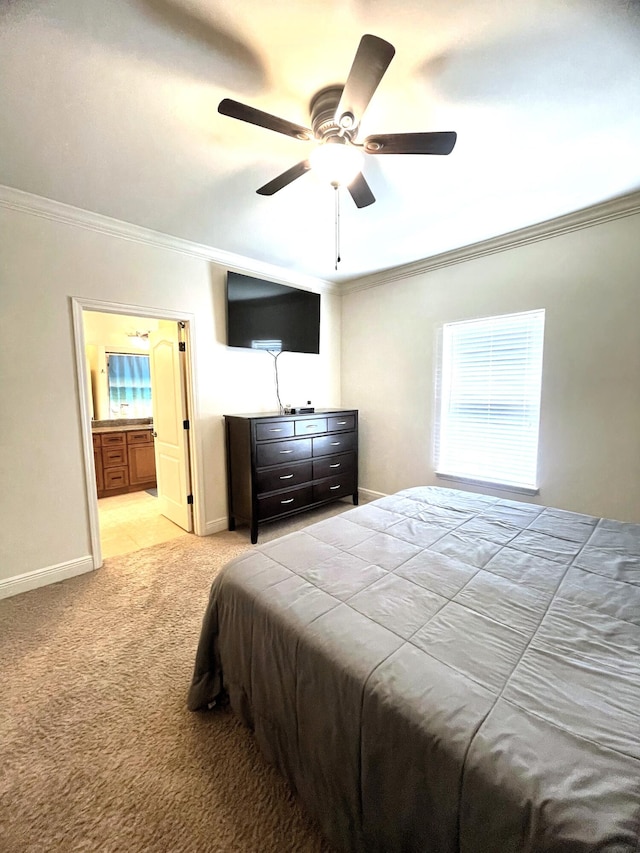 carpeted bedroom with crown molding, ensuite bath, and ceiling fan