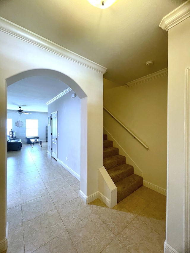 staircase with tile patterned flooring, ceiling fan, and ornamental molding