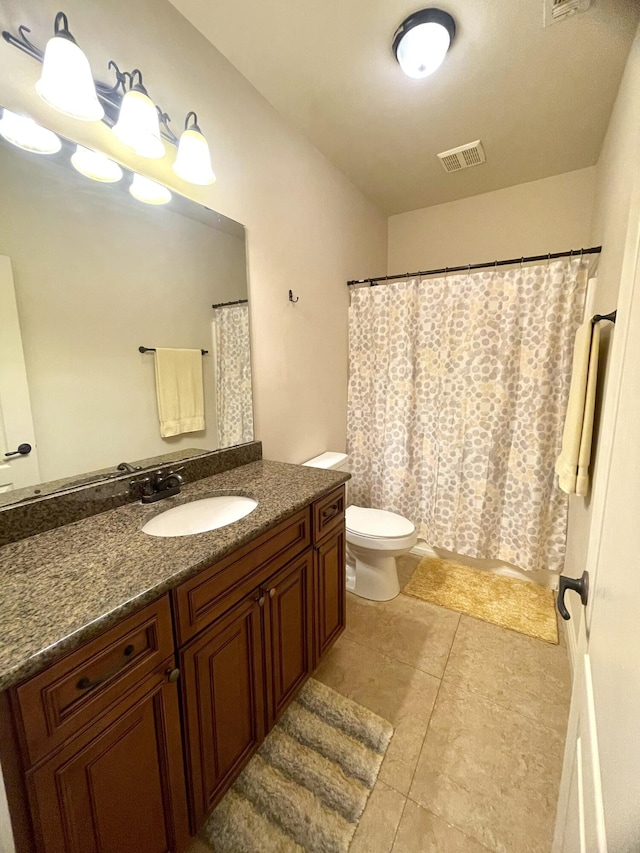 bathroom with tile patterned floors, toilet, and vanity