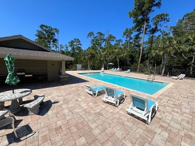 view of swimming pool with a patio area