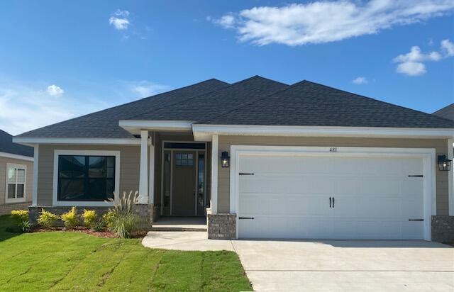 view of front facade with a garage and a front yard