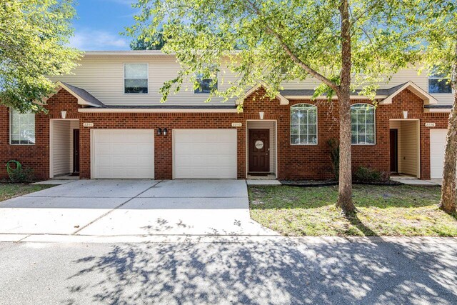 2240 Hadleigh Hills Ct, Navarre, FL 32566 - view of front of home with concrete driveway, brick siding, and an attached garage