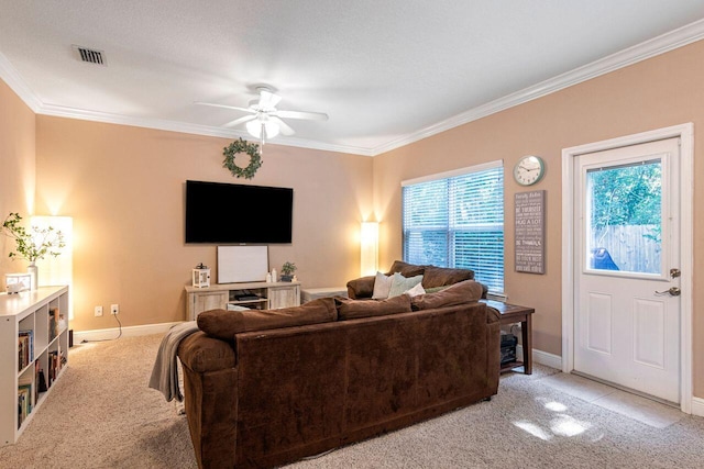 carpeted living room with crown molding and ceiling fan