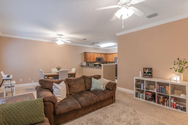 carpeted living room with ceiling fan and ornamental molding