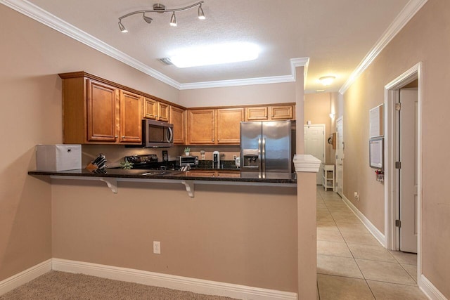 2240 Hadleigh Hills Ct, Navarre, FL 32566 - kitchen with appliances with stainless steel finishes, a peninsula, brown cabinets, crown molding, and a breakfast bar area
