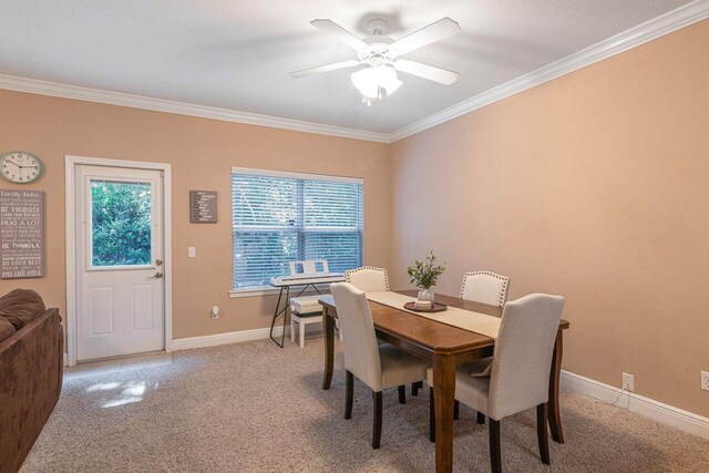 2240 Hadleigh Hills Ct, Navarre, FL 32566 - dining area featuring crown molding, a ceiling fan, light carpet, and baseboards