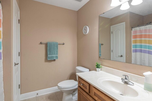 2240 Hadleigh Hills Ct, Navarre, FL 32566 - full bath with tile patterned floors, vanity, toilet, baseboards, and a shower with curtain