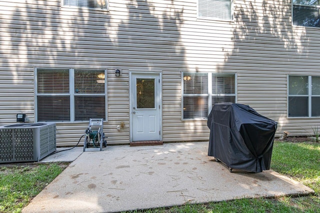 rear view of property featuring central air condition unit and a patio area