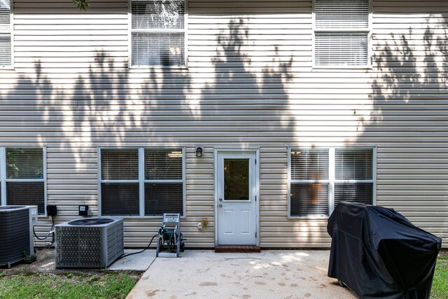 2240 Hadleigh Hills Ct, Navarre, FL 32566 - rear view of house featuring a patio area and central AC unit