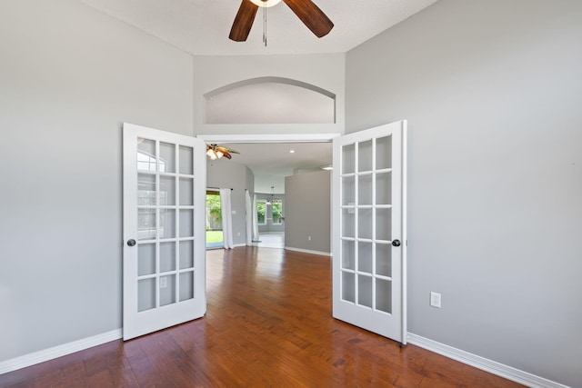 unfurnished room featuring french doors, a textured ceiling, dark wood-type flooring, and ceiling fan