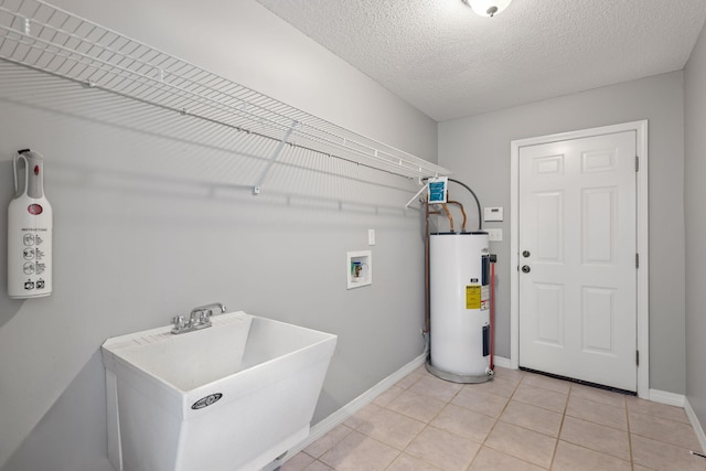 laundry room with a textured ceiling, light tile patterned floors, sink, electric water heater, and washer hookup