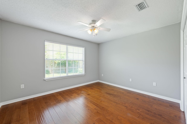 spare room featuring a textured ceiling, ceiling fan, and dark hardwood / wood-style floors