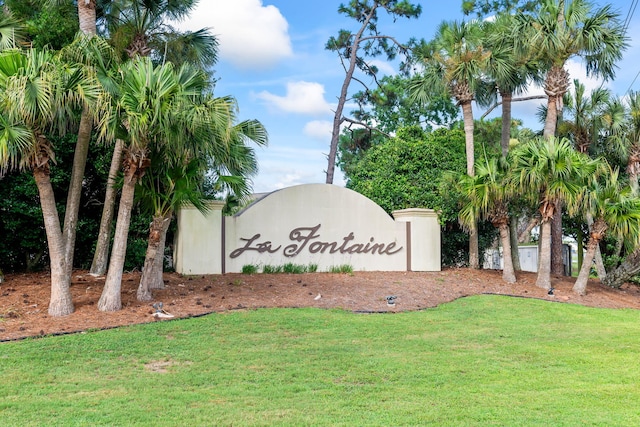 community / neighborhood sign with a lawn