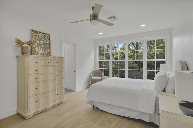 bedroom with light wood-type flooring, multiple windows, and ceiling fan