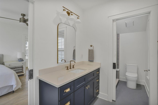 bathroom featuring vanity, toilet, hardwood / wood-style flooring, and a shower