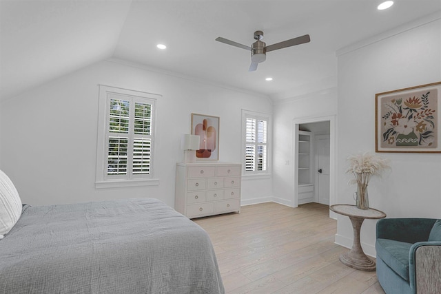 bedroom with light wood-type flooring, vaulted ceiling, and ceiling fan