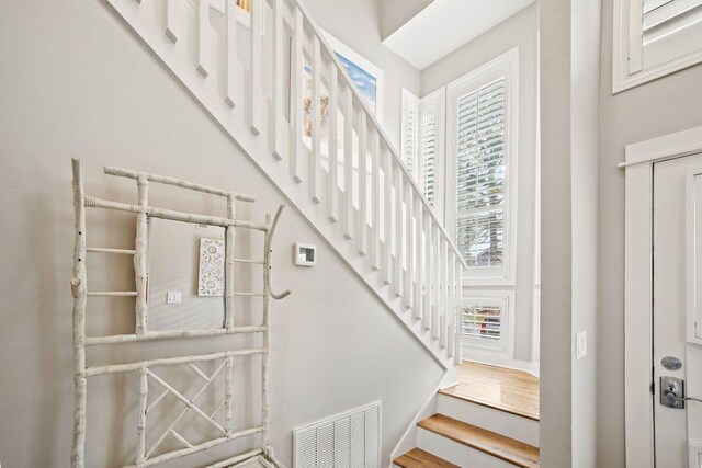 staircase with hardwood / wood-style floors