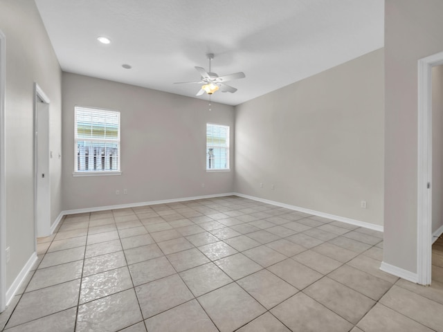 tiled spare room featuring ceiling fan