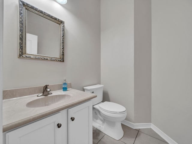 bathroom featuring tile patterned floors, vanity, and toilet