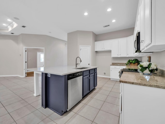 kitchen featuring white cabinetry, sink, a center island with sink, light tile patterned floors, and appliances with stainless steel finishes